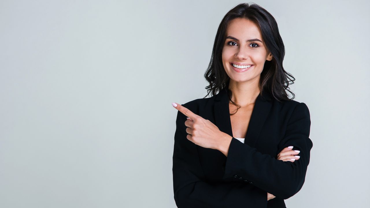 young businesswoman pointing away