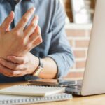 massage on his hand and arm for relief pain from hard working